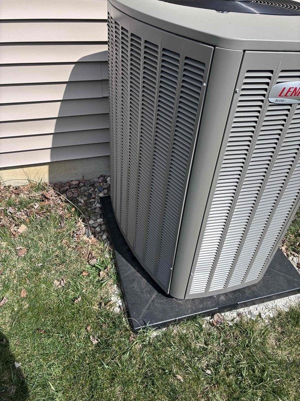 Completed warranty inspection on recently installed Lennox outdoor condensing unit. Unit was verified to be properly mounted on vibration-dampening pad with adequate clearance from structure. Connected Yellow Jacket Titan 4-valve manifold gauge set to service ports and confirmed refrigerant pressures are within manufacturer specifications for optimal system performance.