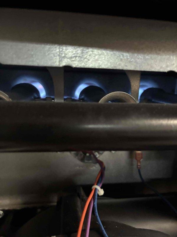 Completed warranty inspection on Daikin gas furnace system. Verified proper burner operation with all three burner ports igniting correctly and producing stable blue flames. Confirmed heat exchanger assembly functioning within normal parameters with no visible signs of damage or deterioration. Accessed manufacturer technical documentation via Daikin Comfort portal to reference wiring diagrams and diagnostic flash codes for system verification. Inspected electrical connections at burner assembly including ignition and flame sensor wiring. All components operating as designed with no deficiencies noted. System returned to normal heating operation.