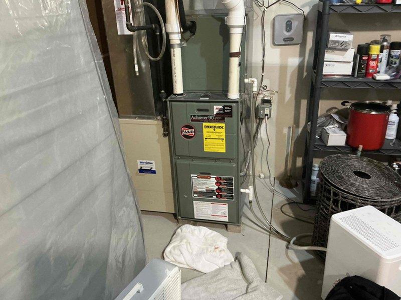 Completed comprehensive assessment of existing residential HVAC system located in basement utility area for equipment replacement estimate. Evaluated current Ruud furnace unit, associated ductwork configuration, PVC condensate drainage system, humidification equipment, and overall mechanical room layout. Documented equipment specifications, existing installation conditions, available clearances, and utility connections including electrical service and gas lines. Photographed system components to support replacement recommendations and ensure accurate equipment sizing for proposed new installation.