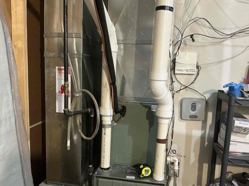 Completed comprehensive assessment of existing residential HVAC system located in basement utility area for equipment replacement estimate. Evaluated current Ruud furnace unit, associated ductwork configuration, PVC condensate drainage system, humidification equipment, and overall mechanical room layout. Documented equipment specifications, existing installation conditions, available clearances, and utility connections including electrical service and gas lines. Photographed system components to support replacement recommendations and ensure accurate equipment sizing for proposed new installation.