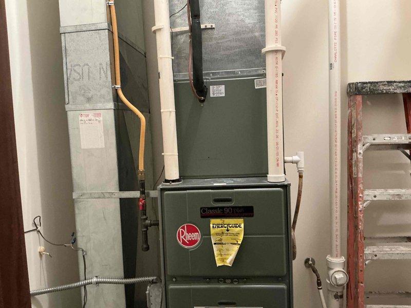 Completed comprehensive HVAC system evaluation for equipment replacement in residential basement mechanical room. Assessed existing Rheem Classic 90 Plus high-efficiency gas furnace and associated air handler system, documenting current equipment configuration, ductwork layout, and supporting infrastructure including PVC condensate/venting lines, copper gas supply line, electrical service connections, and flexible duct transitions. Photographed equipment conditions, manufacturer labels, energy ratings, and mechanical room layout to provide detailed documentation for replacement system specifications and installation planning.