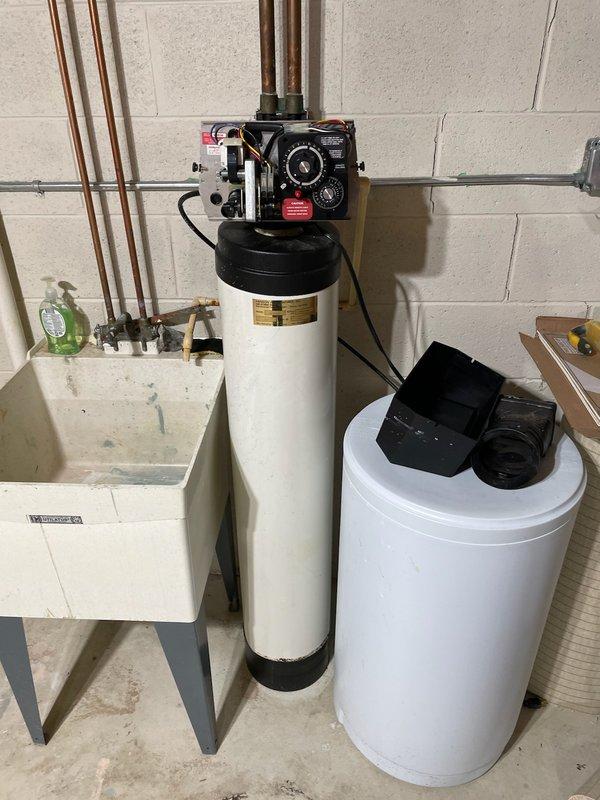 Installed complete water treatment system in basement utility area, including water softener with programmable control valve and brine tank for salt storage. Connected system to existing copper plumbing infrastructure with proper shutoff valves, ensuring integration with water heater and utility sink. Tested all connections for proper operation and verified system settings for optimal water conditioning performance.