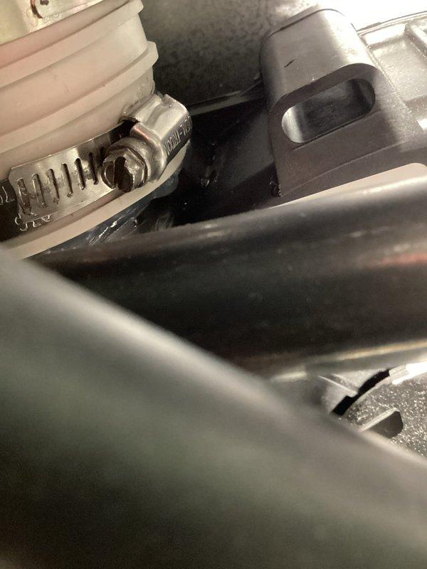 # Warranty Service Completed

Performed warranty inspection on residential HVAC system. Examined internal components including refrigerant lines, drain connections, and condensate management system. Verified proper installation of drain hose with secure clamp connections and confirmed all mechanical fittings were properly seated. Documented equipment nameplate information and serial number for warranty verification. All components found to be functioning within manufacturer specifications with no defects identified.