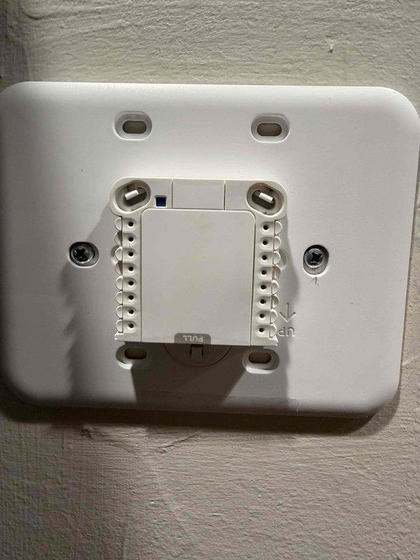 Responded to no heat call and performed diagnostic inspection of thermostat system. Found thermostat had become disconnected from wall mount base, interrupting power and communication to HVAC equipment. Properly reconnected thermostat to mounting base, verified all wire terminals were secure and making proper contact, and confirmed system restored to normal heating operation with successful call for heat.