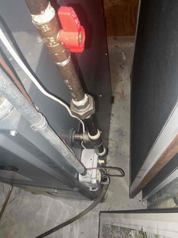 Conducted comprehensive assessment of existing HVAC system for equipment replacement estimate. Inspected current mechanical infrastructure including copper supply lines, shut-off valves, and pipe insulation condition in utility area. Documented plumbing connections, pressure relief components, and existing pipe routing configuration to determine compatibility requirements for new system installation. Evaluated structural access points and clearances necessary for equipment removal and replacement, noting concrete floor conditions and available workspace in mechanical room for staging and installation activities.