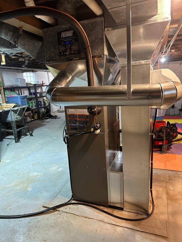 Completed full HVAC system installation in residential basement, including new Patriot high-efficiency furnace and Lennox air handler with Thermann branded components. Installed copper refrigerant line sets with proper insulation, white PVC condensate drainage and venting system, and gray metal supply/return ductwork with plenum transitions. Mounted all equipment on protective base pads over concrete flooring with proper clearances for code compliance and future maintenance access. Ran electrical connections, secured all piping and ductwork, verified system startup, and tested all components for proper operation.