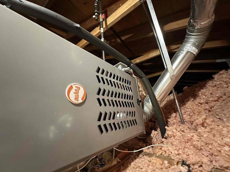 Completed HVAC system replacement including installation of new air handler unit in attic space and associated electrical panel upgrades in basement utility area. The new air handler was properly positioned among ceiling joists with appropriate clearances, connected to existing ductwork using metallic flexible ducting, and integrated with refrigerant lines. Electrical service was upgraded with installation of new circuit breaker panels to support the HVAC equipment, featuring organized conduit routing and proper wire management. All components were installed per manufacturer specifications and local code requirements, with the system tested and verified operational upon completion.