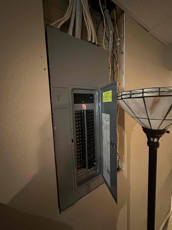 Completed comprehensive HVAC system evaluation for residential forced-air furnace and air handler replacement in basement utility area. Assessed existing beige furnace unit with curved gray supply ductwork, examined electrical panel capacity and circuit breaker configuration to ensure adequate power supply for new equipment installation, and documented current system layout including insulated duct runs and mechanical connections for replacement specifications.