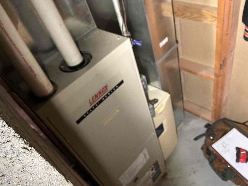 Completed full HVAC system replacement including installation of new Lennox furnace in basement utility area with proper PVC venting and a new outdoor condensing unit mounted on concrete pad. Both units were professionally installed with appropriate electrical connections, ductwork integration, and proper drainage to ensure optimal system performance and efficiency.