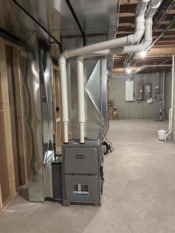 Completed comprehensive duct cleaning service for residential HVAC system in basement mechanical room. Cleaned and sanitized all accessible ductwork including main supply trunk lines, return air ducts, and branch runs connected to gray furnace unit and associated air handling equipment. Removed accumulated dust, debris, and contaminants from PVC ductwork system using specialized rotary brush equipment and high-powered vacuum with HEPA filtration to improve indoor air quality and system efficiency.