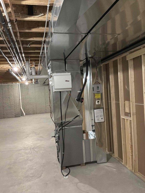 Completed comprehensive duct cleaning service for residential HVAC system in basement mechanical room. Cleaned and sanitized all accessible ductwork including main supply trunk lines, return air ducts, and branch runs connected to gray furnace unit and associated air handling equipment. Removed accumulated dust, debris, and contaminants from PVC ductwork system using specialized rotary brush equipment and high-powered vacuum with HEPA filtration to improve indoor air quality and system efficiency.