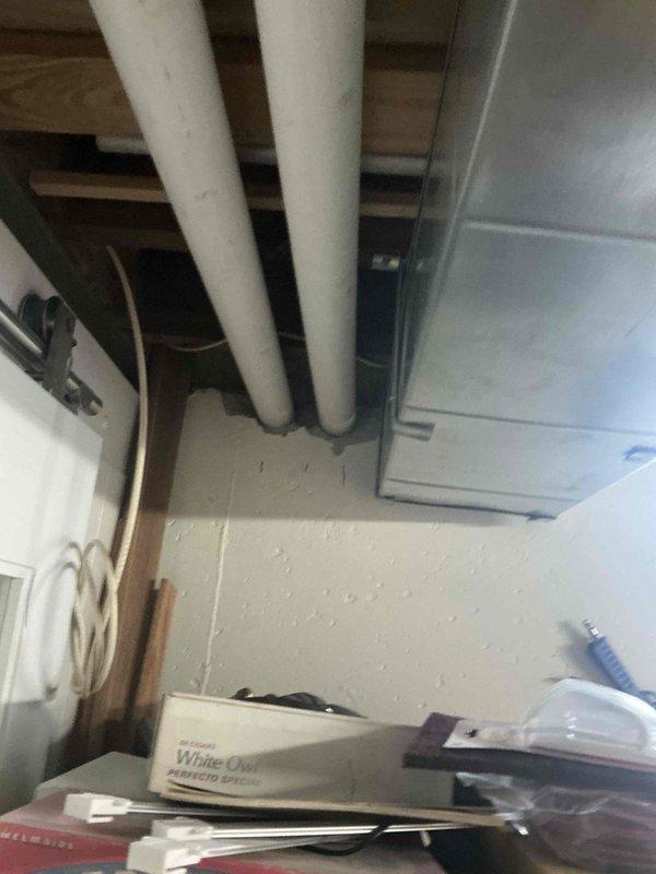 Completed comprehensive HVAC system evaluation in basement utility area for equipment replacement estimate. Assessed existing infrastructure including ductwork configuration, available clearances around current water heater installation, and spatial requirements for new HVAC equipment placement. Documented current mechanical room layout with exposed ceiling joists, PVC drainage lines, and metal ductwork components to determine optimal positioning for replacement system and ensure proper clearances meet code requirements.