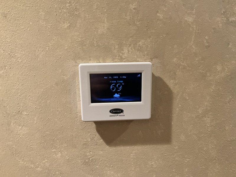 Performed comprehensive evaluation and measurements of existing HVAC system for complete replacement estimate. Assessed current air handler unit dimensions and clearances in mechanical space to determine equipment specifications for new installation. Documented existing Carrier Infinity Touch thermostat system currently displaying operational parameters, which will be evaluated for compatibility with proposed replacement equipment or potential upgrade requirements during system changeout.