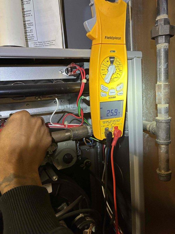 # HVAC Tune-Up Completed

Performed comprehensive maintenance and diagnostic testing on residential HVAC system. Utilized Fieldpiece SC680 digital multimeter to measure electrical parameters throughout the unit, recording voltage reading of 26.9 volts at furnace control board and verifying proper electrical supply to heating components. Conducted amperage testing with clamp meter, measuring 154 amp reading at compressor motor to confirm proper current draw within manufacturer specifications.

Inspected all accessible mechanical components including compressor housing, refrigerant lines, and threaded pipe fittings for signs of wear or leakage. Verified all electrical connections were secure and functioning properly. Confirmed proper operation of heating and cooling systems with all readings within normal operating parameters. Unit tested and left in proper working condition.