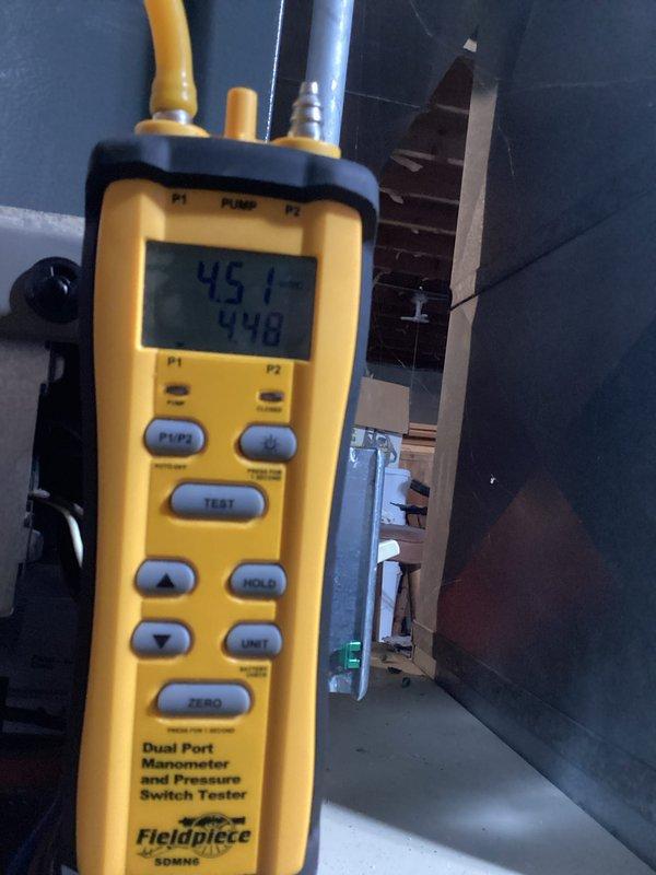 Completed scheduled HVAC maintenance inspection on residential system. Performed diagnostic testing using digital manometer to verify proper system pressures, recording static pressure readings of 45.1 and 448 pascals to ensure optimal airflow and equipment operation. Inspected air handler unit, drainage piping, and associated mechanical components in utility space, confirming all equipment is functioning within manufacturer specifications with no issues identified.