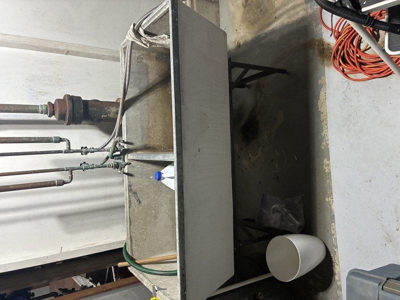 Responded to emergency call for burst copper pipe in basement mechanical room. Upon arrival, found severely corroded copper water line with active leak at fitting connection, causing water damage and staining on surrounding concrete walls. Shut off main water supply to prevent further flooding and damage to the area.

Removed deteriorated section of copper piping showing extensive oxidation and corrosion at joints and fittings. The aged copper system had failed at a compromised connection point where rust and mineral buildup had weakened the pipe integrity. Cut out damaged section and prepared pipe ends for replacement.

Installed new copper pipe segment with proper fittings and soldered connections to restore water line integrity. Tested all joints for leaks and verified proper water pressure throughout the system. Confirmed no additional weak points in adjacent piping. Restored water service to the property and verified all fixtures operating correctly.
