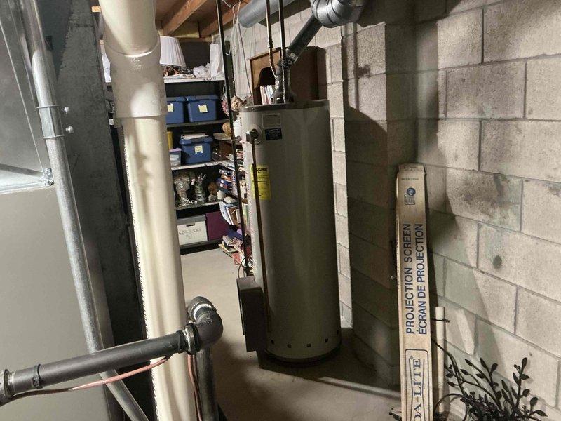 Completed HVAC system assessment in basement mechanical room for equipment replacement estimate. Documented existing furnace/air handler unit, water heater, ductwork configuration, PVC ventilation system, and copper piping layout to provide comprehensive replacement options for aging heating and cooling equipment.