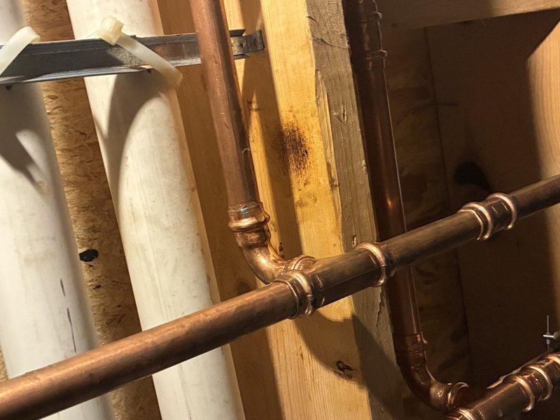 # Outdoor Spigot Replacement and Plumbing Repair

Replaced deteriorated outdoor spigot assembly showing significant water damage and corrosion. Installed new copper piping with proper connections and elbow fittings throughout the wall cavity, addressing existing leak issues and structural water staining. All connections were soldered to code and tested for proper function and water-tight integrity.