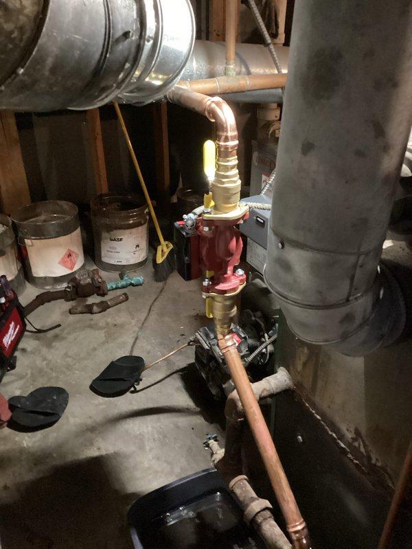 Completed comprehensive boiler system inspection and maintenance in residential basement utility area. Serviced oil-fired boiler unit including burner assembly, fuel pump, and associated copper piping with pressure relief valve system. Verified proper operation of all components, checked connections throughout the heating system, and ensured ductwork integration was functioning correctly with no visible leaks or safety concerns detected.