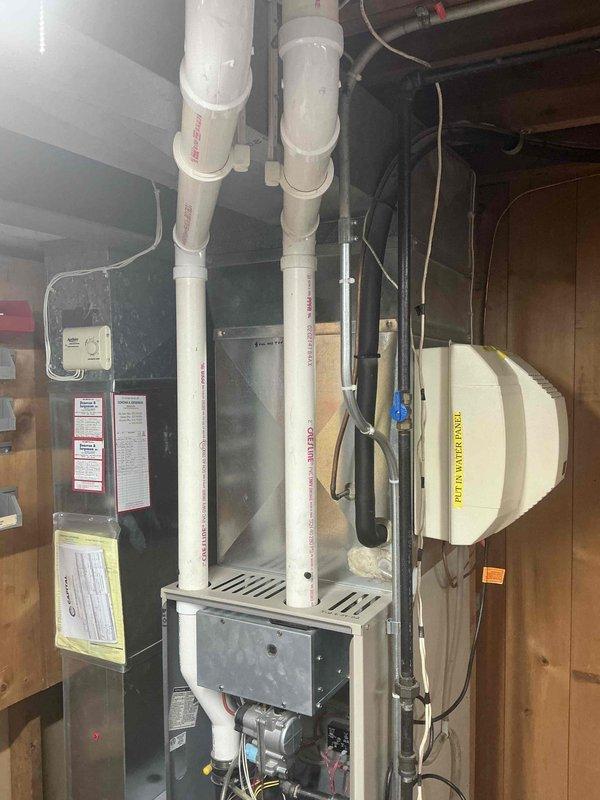 Completed comprehensive HVAC system estimate for full equipment replacement at residential property. Evaluated existing basement furnace installation with current PVC venting system, humidifier integration, and electrical connections, along with exterior condensing unit positioned on concrete paver pad with proper electrical disconnect and line set connections. Provided detailed replacement recommendations for both indoor and outdoor components to upgrade system efficiency and reliability.