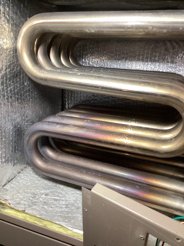 Completed scheduled HVAC maintenance inspection on furnace/air handler unit #301. Performed visual inspection of evaporator coil assembly, confirming heat exchanger tubing shows normal operational heat discoloration patterns with no signs of damage or refrigerant leaks. Verified all system components, safety labels, and insulation are intact and properly secured. Unit operating within normal parameters.