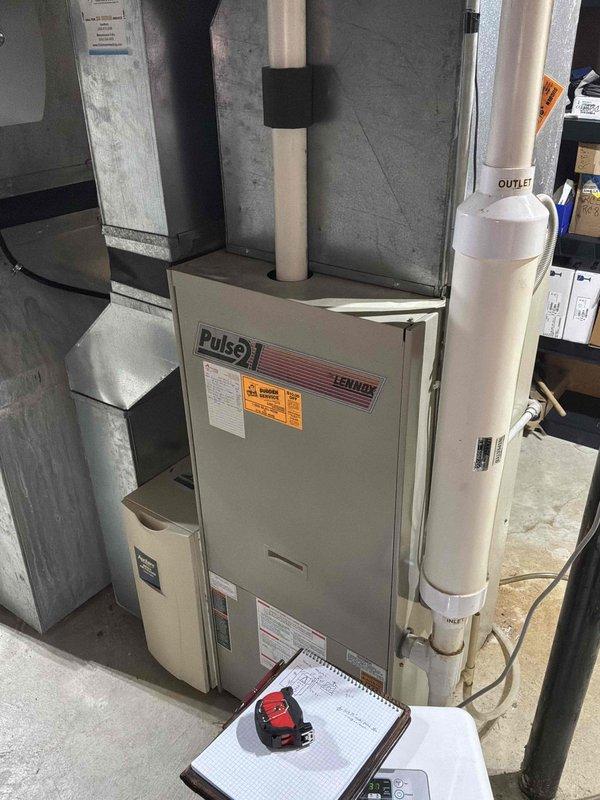 Conducted comprehensive assessment of existing Lennox Pulse furnace system for complete HVAC replacement. Evaluated current equipment specifications, measured existing ductwork configurations, and documented system dimensions including 15", 33", and 22-23" clearances. Prepared detailed replacement estimates comparing multiple equipment options: Silver tier package featuring 2.5-ton air handler with programmable V-Stat thermostat and 10-15-30 year warranty options, and Bronze tier package with 3-stage furnace system offering enhanced efficiency ratings of 979 AFUE. Documented CFM requirements at 915 cubic feet per minute to ensure proper system sizing for adequate airflow and climate control throughout the residence.