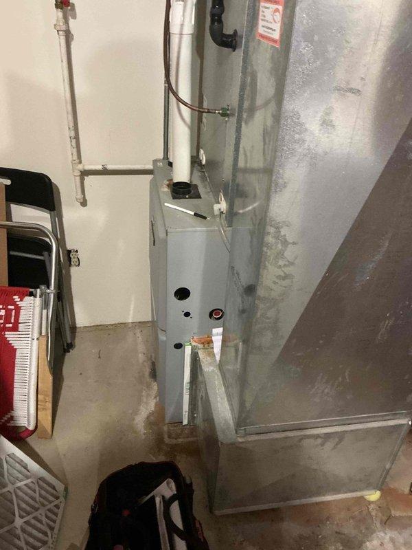 Completed comprehensive HVAC system assessment and duct cleaning estimate for vertical air handler unit located in mechanical room. Inspected galvanized metal ductwork and air handler showing surface moisture condensation, oxidation patterns, and operational wear typical of aging systems. Documented existing conditions including copper refrigerant lines, electrical connections, and mounted control panel to provide accurate scope of work for proposed duct cleaning services and system maintenance recommendations.