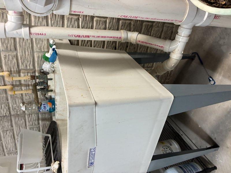 Completed comprehensive plumbing inspection of residential kitchen and basement utility systems. Examined under-sink garbage disposal installation, verifying proper mounting, electrical connections, and PVC drain configuration, as well as basement water supply system including main distribution lines, shut-off valves, and mechanical equipment connections. All components found to be properly installed and functioning within normal parameters.