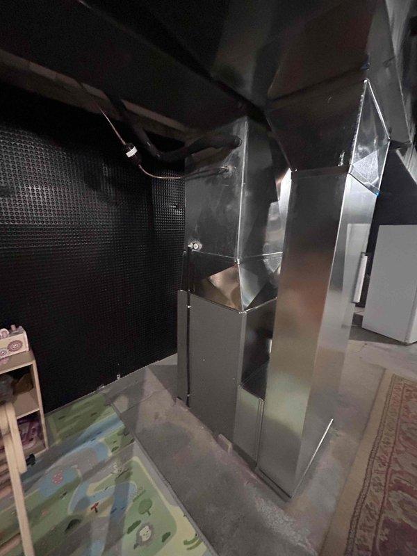Completed installation of new HVAC furnace system in residential basement utility area. Installed vertical furnace unit with metallic ductwork, connected black flexible supply ducts to upper plenum, and integrated system with existing ductwork infrastructure. Mounted and programmed Honeywell Home ProSeries digital thermostat on main level, configured heating and humidity control settings, and verified proper communication between thermostat and furnace unit for optimal system operation and temperature regulation.