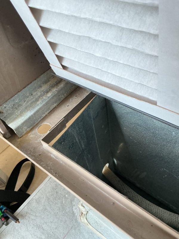 Completed routine maintenance inspection on residential furnace system. Documented current equipment condition, verified air filter installation and cleanliness, and inspected internal components including condensate drain pan and drainage system for proper operation. Unit found to be in good working condition with all safety labels intact and legible.