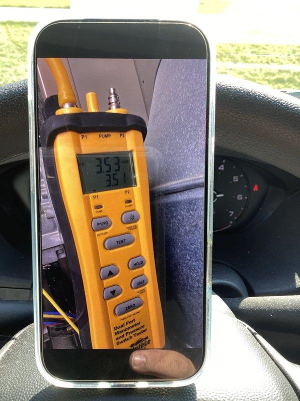 Responded to service callback for HVAC system evaluation. Upon arrival, performed diagnostic pressure testing using dual port manometer on the installed unit. Measured system pressures with readings of 353 on P1 and 33 on P2 to verify proper refrigerant charge and system operation. Inspected vertically-mounted air handler/furnace unit in mechanical closet, confirming all safety labels, energy guide documentation, and manufacturer specifications remained properly affixed and legible. Verified electrical panel connections, ductwork attachments, and copper refrigerant lines showed no signs of damage or deterioration. System operating within normal parameters with no anomalies detected.