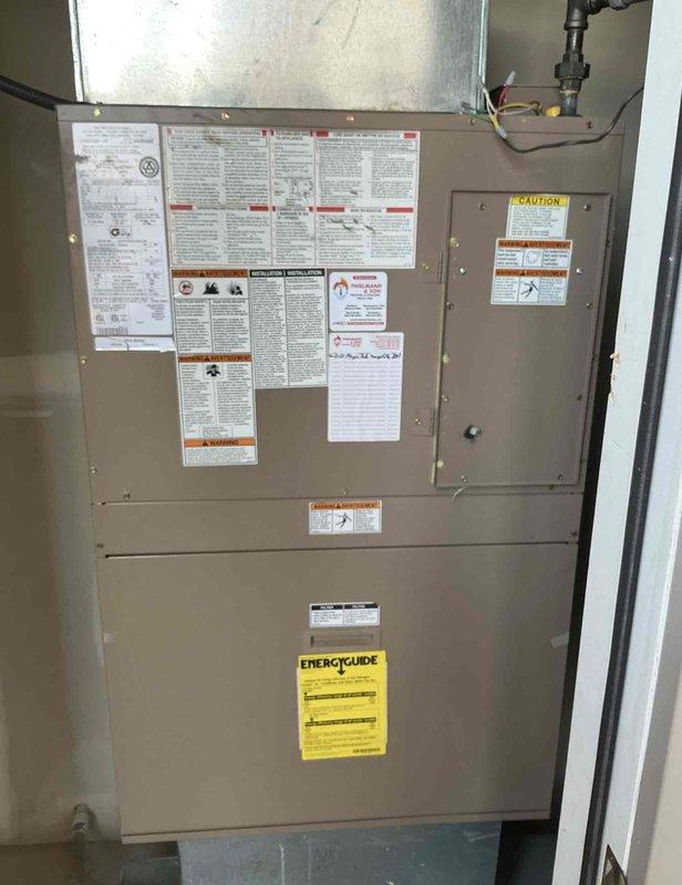 Responded to service callback for HVAC system evaluation. Upon arrival, performed diagnostic pressure testing using dual port manometer on the installed unit. Measured system pressures with readings of 353 on P1 and 33 on P2 to verify proper refrigerant charge and system operation. Inspected vertically-mounted air handler/furnace unit in mechanical closet, confirming all safety labels, energy guide documentation, and manufacturer specifications remained properly affixed and legible. Verified electrical panel connections, ductwork attachments, and copper refrigerant lines showed no signs of damage or deterioration. System operating within normal parameters with no anomalies detected.