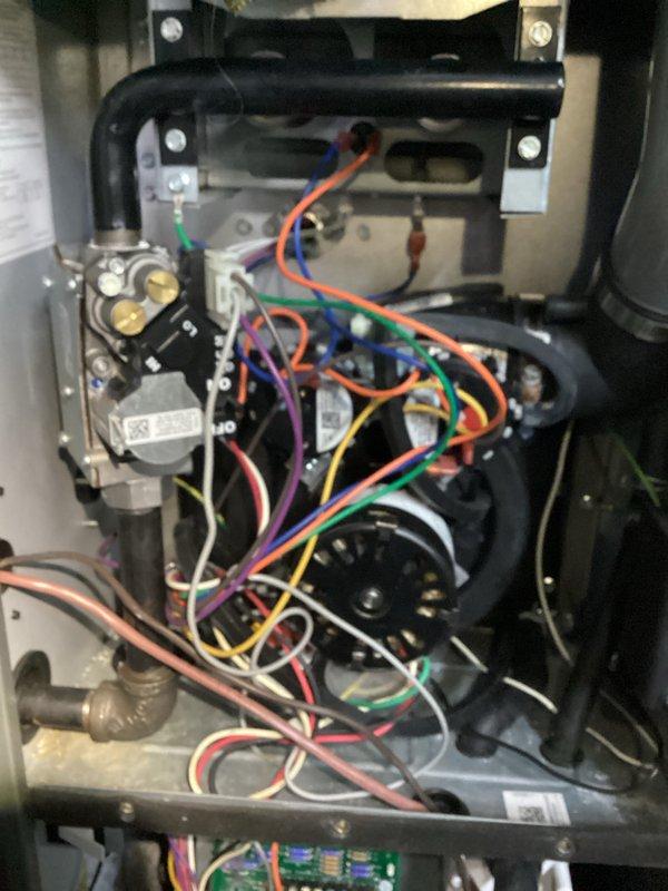 Completed prepaid HVAC maintenance visit and performed system inspection. Documented internal furnace components including gas valve assembly, blower motor housing, heat exchanger, wiring harness, and control board, all found to be in proper working condition. Photographed associated plumbing drainage system connected to the unit to verify proper condensate management and system integration.