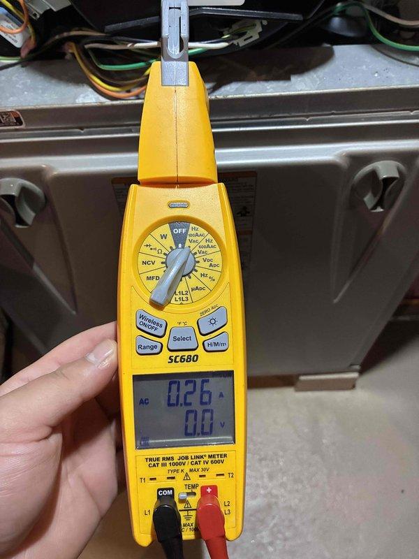 Completed prepaid HVAC maintenance visit and performed system diagnostics using digital multimeter. Measured electrical current at 0.26 amps and verified voltage readings, then conducted microamp testing showing -4.6 μA to assess system performance and ensure all electrical components were operating within normal parameters.