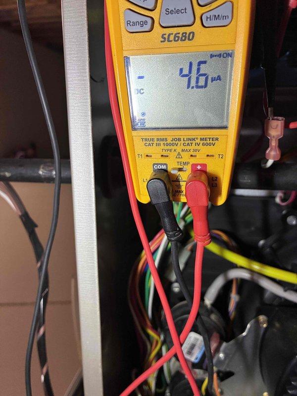 Completed prepaid HVAC maintenance visit and performed system diagnostics using digital multimeter. Measured electrical current at 0.26 amps and verified voltage readings, then conducted microamp testing showing -4.6 μA to assess system performance and ensure all electrical components were operating within normal parameters.