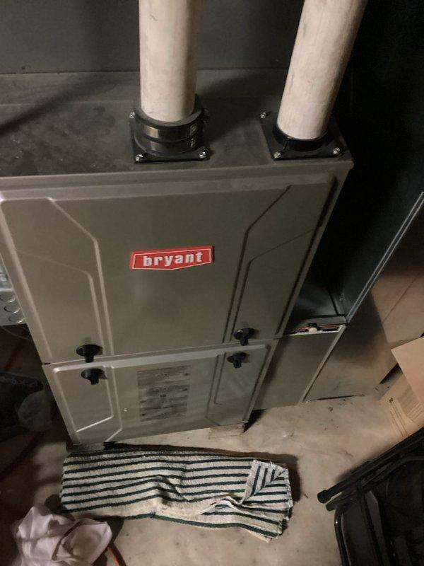 Completed routine maintenance and inspection on Bryant residential gas furnace system. Performed visual assessment of unit operation, verified proper venting configuration with dual PVC intake and exhaust pipes, and confirmed all safety mechanisms functioning correctly. Unit found in good operating condition with no immediate repairs required.