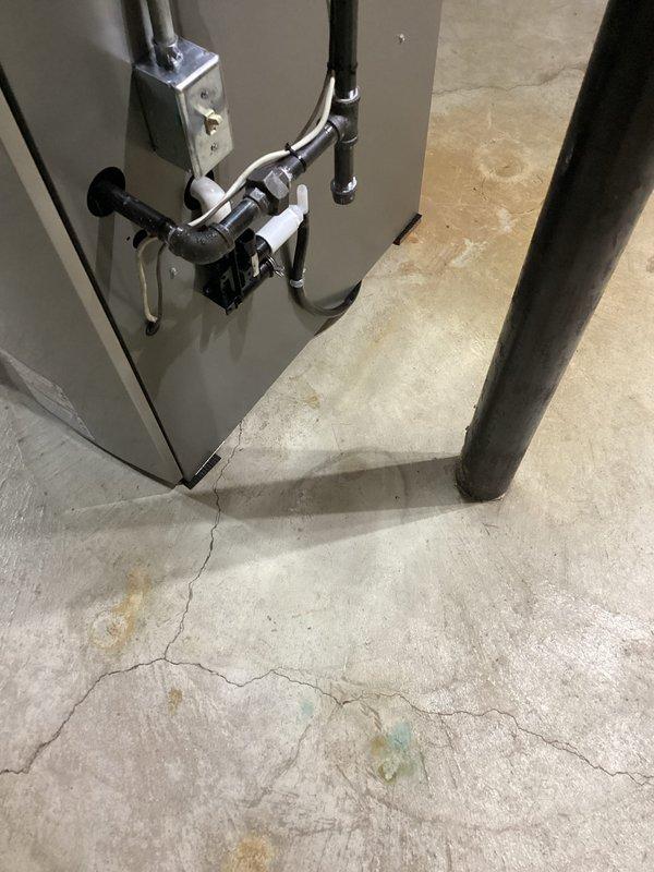 Completed furnace installation in basement utility area, including proper placement of HVAC unit, connection of refrigerant lines with insulation, and installation of associated piping and ductwork. All components were secured to concrete foundation, with door closer mechanism installed on utility room access door to ensure proper ventilation control and code compliance.