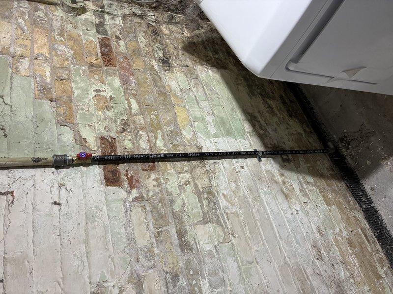 Responded to gas leak concern and performed comprehensive pressure test of gas piping system. Upon inspection, identified deteriorated flexible gas connector with visible corrosion and compromised sealing at junction point near HVAC equipment. Testing confirmed pressure drop indicating active leak at connector interface. Replaced defective flexible gas line with new code-compliant connector, pressure tested system to 15 PSI for 15 minutes with zero pressure loss, and verified all connections with leak detection solution. System restored to safe operating condition and all gas appliances confirmed functional.