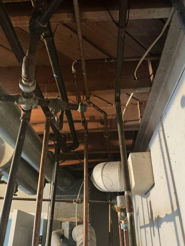 Performed comprehensive gas pressure test on commercial plumbing system with exposed piping infrastructure in basement utility area. Inspected all gas lines, connections, and fittings throughout the mechanical space, including copper supply lines, black iron gas piping, and associated pressure vessels. All connections tested and verified to be leak-free with proper operating pressure maintained throughout the system.