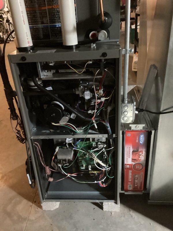 Completed prepaid HVAC maintenance visit on residential heating and cooling system. Performed comprehensive inspection of furnace unit with access panel removed, verifying proper operation of blower motor assembly, examining electrical connections and wiring integrity throughout the system, and checking heating elements and sensors for proper function. Inspected control board and diagnostic panel mounted on exterior cabinet for any error codes or operational issues.

Evaluated condensate pump system operation, confirming green indicator light showed active status and proper electrical supply. Examined copper refrigerant line connections running to condensate pump, verifying secure fittings and absence of refrigerant leaks. Noted minor water staining on concrete floor around pump base consistent with normal condensate drainage patterns. All components found operating within normal parameters with no immediate service concerns identified during this scheduled maintenance inspection.