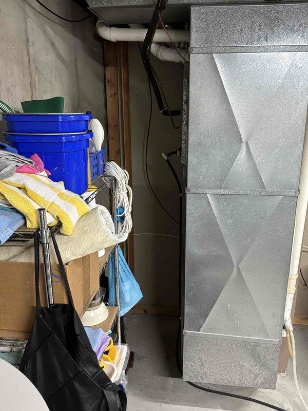 Completed comprehensive HVAC system evaluation in basement utility area for full equipment replacement estimate. Assessed existing furnace and water heater configuration, documented current installation including all PVC venting, condensate drainage systems, and clearance requirements for replacement unit specifications.