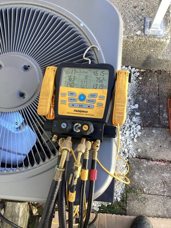 Completed full HVAC system installation featuring a Lennox cylindrical condenser unit mounted on vibration-dampening pad with proper gravel base for drainage and stability. Installed electrical disconnect box with conduit run to unit, routed and insulated refrigerant lines to indoor air handler, evacuated system using vacuum pump to remove moisture and contaminants, and charged system to manufacturer specifications. Performed diagnostic verification using manifold gauges and digital meter, confirming proper refrigerant pressures, temperatures, and system operation across all parameters.