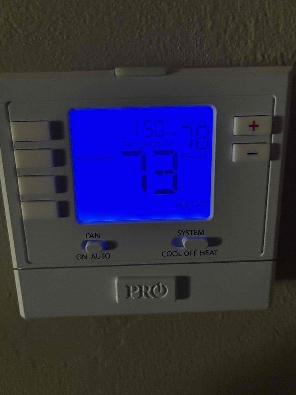 Completed install callback for HVAC system. Verified programmable thermostat installation and proper operation, confirming display functionality, temperature controls, and system mode settings. Inspected and documented air filter condition with wood-framed media filter in place and operating correctly.