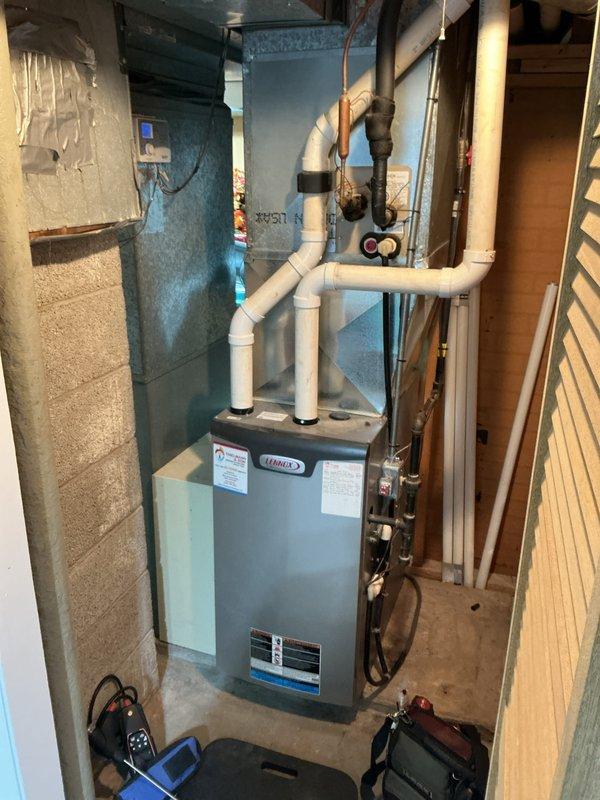 Completed preventative maintenance tune-up on residential gas furnace system in basement mechanical room. Performed comprehensive inspection of unit including burner assembly, heat exchanger, blower motor, and all associated components. Verified proper operation of safety controls, tested ignition sequence, and confirmed adequate combustion air supply and venting through PVC exhaust system.