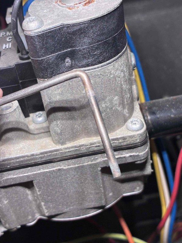 # HVAC Service Report

Responded to no heat call on residential heating system less than 10 years old. Upon arrival, performed diagnostic inspection of gas furnace components. Visual examination revealed significant dust and debris accumulation on gas valve assembly and blower motor housing, indicating lack of routine maintenance. 

Inspected gas valve control mechanism and associated electrical connections, noting all wiring connections intact with red, yellow, and ground wires properly secured. Examined blower motor assembly and found excessive dirt buildup on motor housing and surrounding components affecting system performance. Copper gas supply line showed normal oxidation consistent with age but remained structurally sound with no leaks detected.

Cleaned gas valve exterior and surrounding area to improve component accessibility and heat dissipation. Performed thorough cleaning of blower motor assembly, removing accumulated dust and debris from motor housing and mounting surfaces