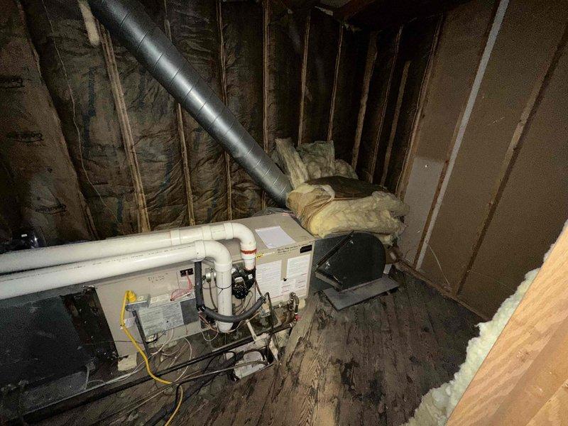 Conducted comprehensive site evaluation for commercial heating equipment installation in multi-level building with unfinished mechanical space. Assessed existing HVAC infrastructure including air handler unit, ductwork routing, and utility connections in attic area with exposed framing. Documented current system configuration, condensate drainage lines, electrical connections, and flexible duct placement. Evaluated structural considerations for equipment placement and identified necessary modifications to accommodate new heating equipment specifications. Provided detailed estimate for commercial-grade heating system replacement including equipment sizing, ductwork modifications, and integration with existing building infrastructure.