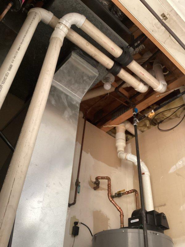 Completed comprehensive tune-up and inspection of HVAC system in residential basement mechanical room. Performed diagnostic measurements using digital testing equipment, verified proper operation of heating and cooling components, inspected PVC drainage piping network and connections, and checked water heater plumbing interfaces to ensure all systems were functioning within manufacturer specifications.