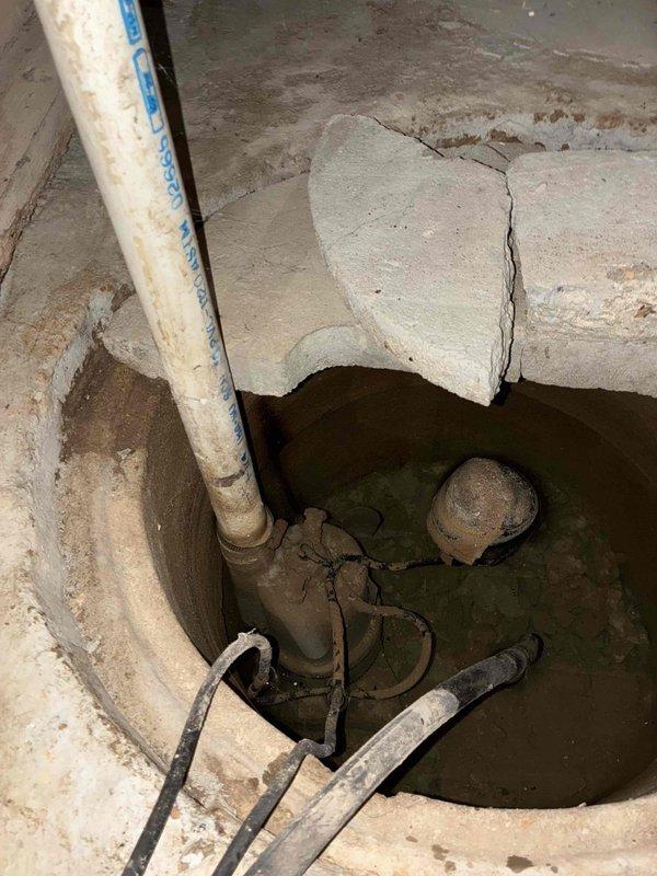 # Sump Pump Installation

Installed new sump pump system in existing concrete basin located in basement crawl space. The installation included connecting the pump to the existing vertical PVC discharge piping, securing all electrical connections and float mechanisms, and testing system operation to ensure proper water removal functionality. The pump was positioned in the deteriorated concrete pit with standing water, addressing the property's groundwater management needs.