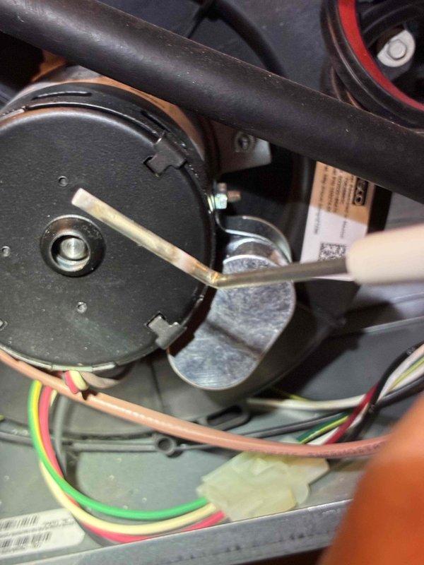 Performed diagnostic inspection and electrical testing on residential furnace system. Using digital multimeter, measured and verified proper voltage readings across gas valve assembly and motor components, confirming electrical functionality at 5486 ohms resistance. Inspected blower motor assembly, fan blade, and associated wiring connections including control wiring harnesses. All components showed normal operational wear with minor dust accumulation on blower assembly, which is typical for seasonal equipment usage.