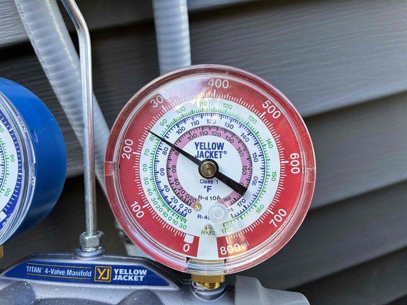 Performed warranty inspection and system diagnostics on recently installed HVAC unit. Connected Yellow Jacket Titan 4-valve manifold gauge set to verify refrigerant pressures and system performance, confirming proper charge levels and operational parameters for R-410A refrigerant system. All pressure readings were within manufacturer specifications, indicating successful installation and proper system function.
